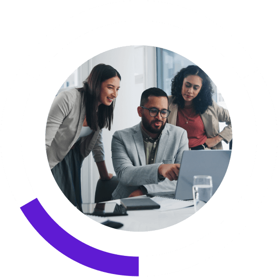 three people working together on a computer